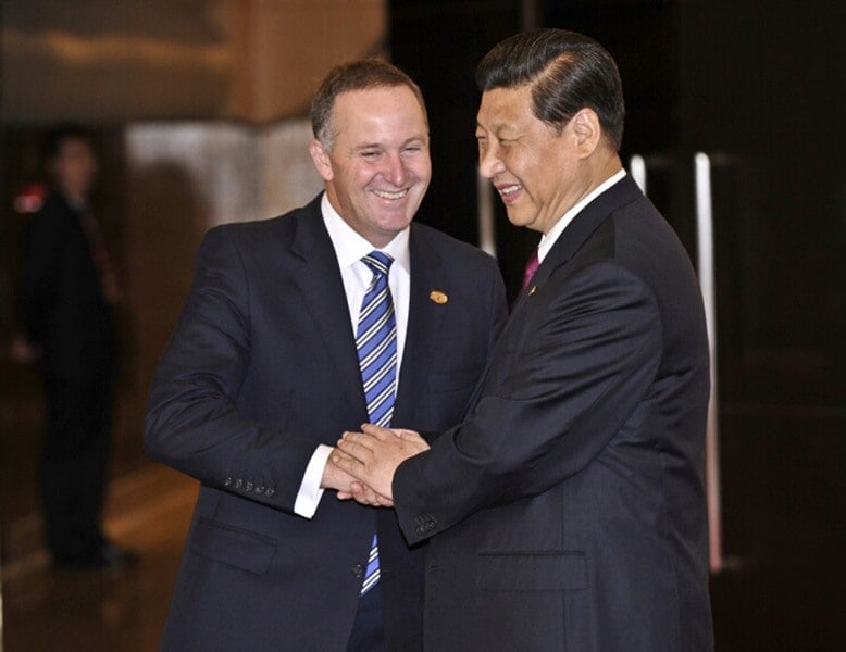 John shaking hands with Xi Jinping at an event held in Beijing