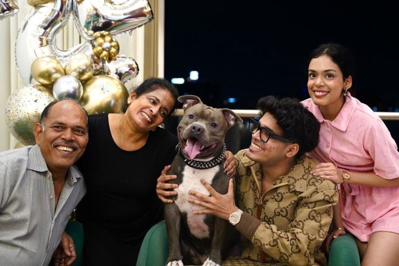 Jonathan Gaming posing with his family and pet dog