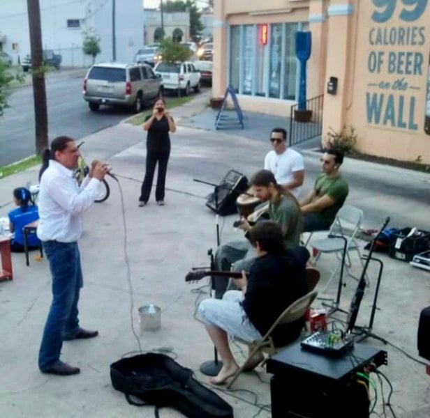 Jonathan Joss (on mic), while performing with The Red Corn Band