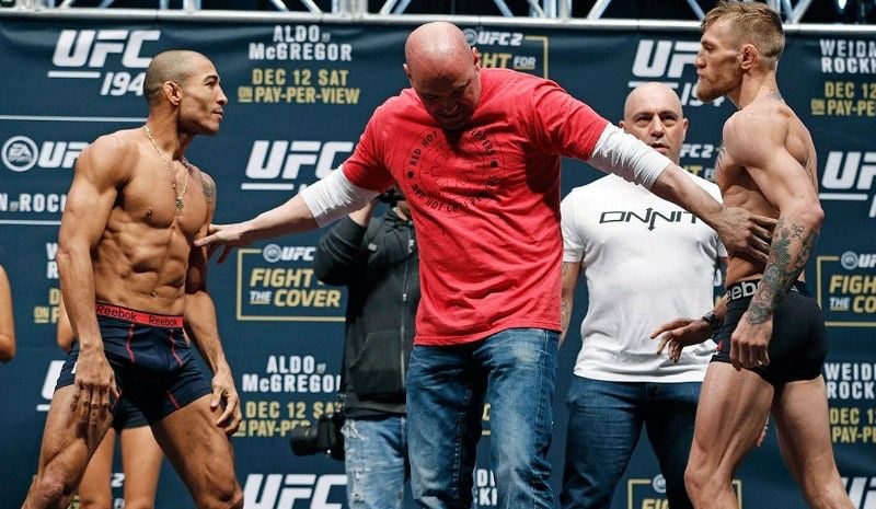Jose Aldo with Conor McGregor (right) during the weigh-in before their fight