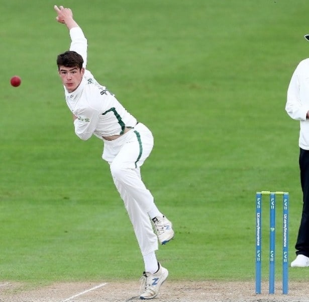 Josh Baker bowling in his debut first-class match