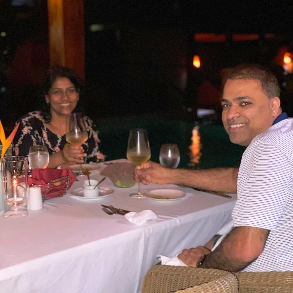 Juli A Mathew enjoying a glass of alcoholic beverage with her husband