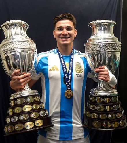 Julian Alvarez with Champions League trophies which he won in 2023