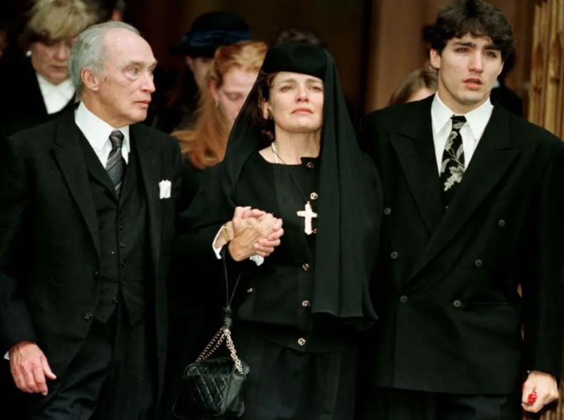 Justin with his father and mother after attending a memorial of his younger brother Michel