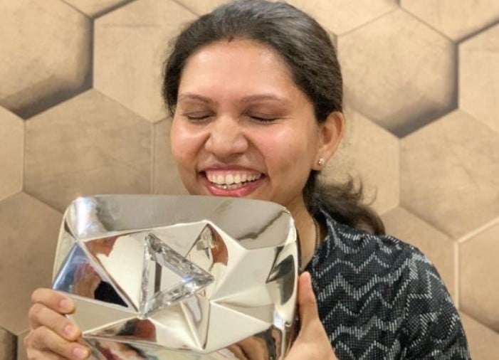 Kabita Singh posing with her Diamond Play Button by YouTube in India