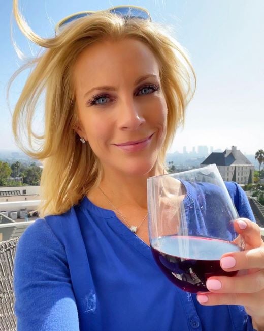 Kacey Montoya holding a glass of wine