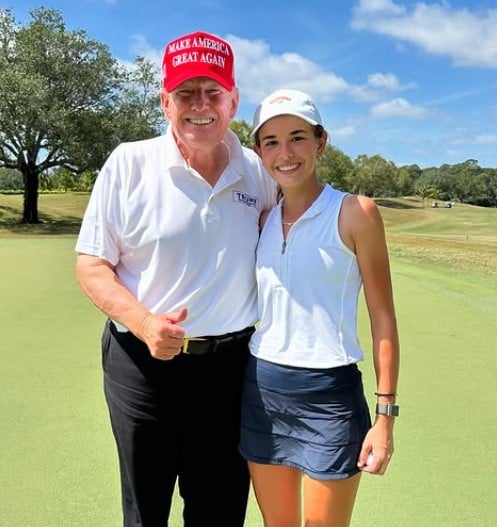 Kai Trump posing with her grandfather at a golf ground