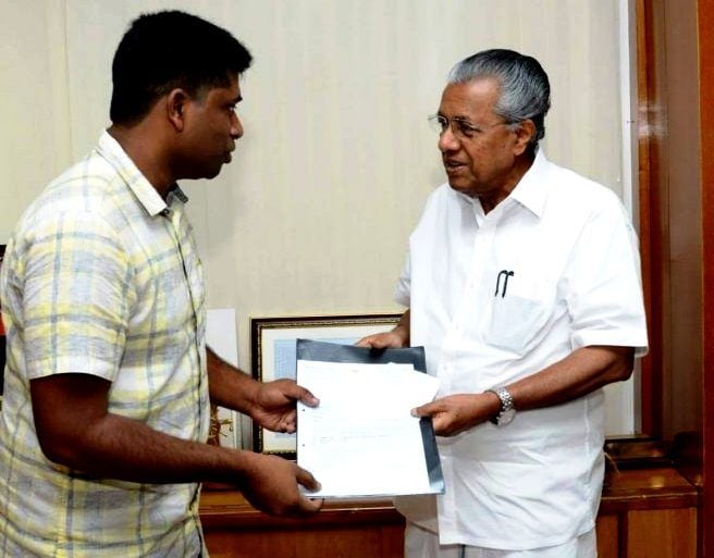 Kannan Gopinathan presenting a cheque of 1 Crores to the Kerala CM Disaster Relief Fund