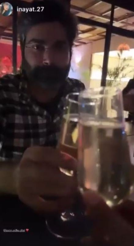 Karan Sidhu holding a glass of wine