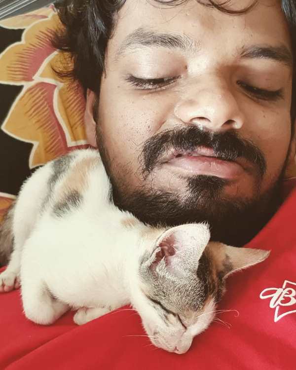Karan Sonawane while playing with his cat