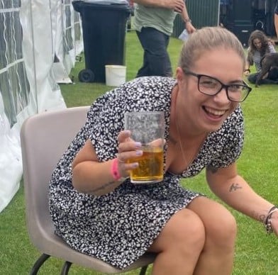 Kelley Jakle posing with a glass of beer