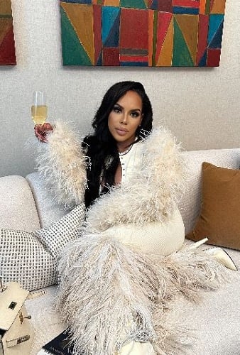 Kelli Ferrell holding a glass of wine