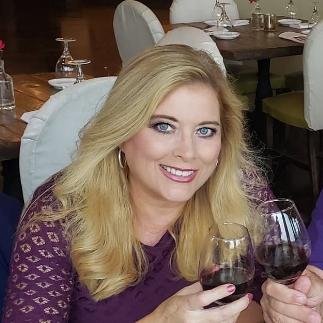 Kelly Cass holding a glass of wine