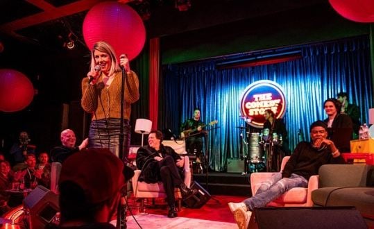 Kelly Rizzo on the stage at The Comedy store paying tribute to her husband