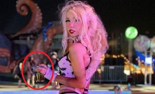 Kenzie Reeves holding a glass of alcohol