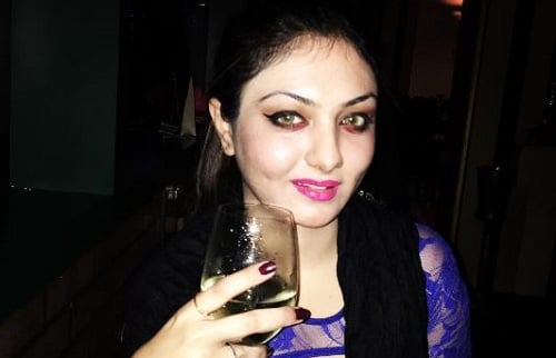Khushi Mukherjee holding a glass of wine