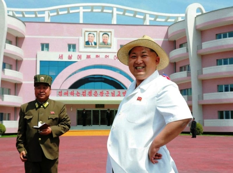Kim posing for a photo in front of a palace that he owns