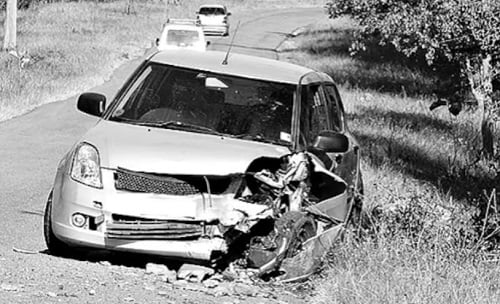 The car Kollam Sudhi was travelling in, seen at the spot where the accident occurred