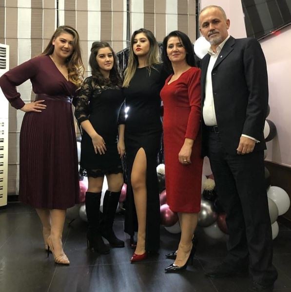 Krisa Caushi (middle) with her family