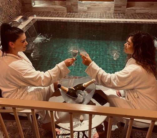 Krisa Caushi (right) drinking wine with her sister