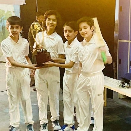 Krish Rao while holding a trophy after winning a cricket match in school