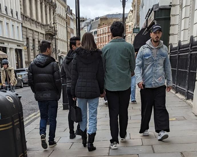 Kriti Sanon (holding purse) with Kabir Bahia (right to her)