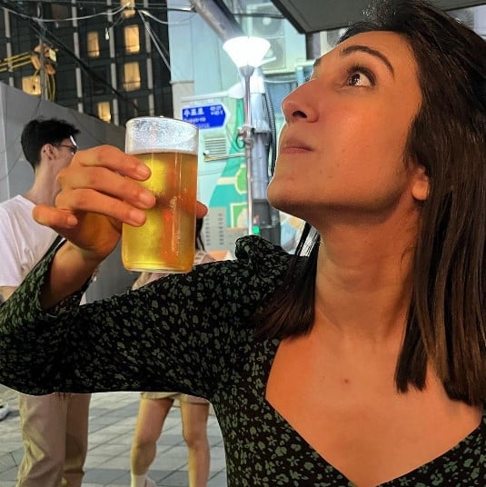 Kriti Vij posing with a glass of alcohol