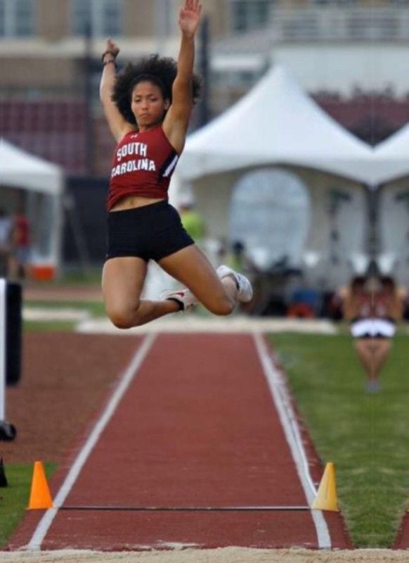 Kryst practicing long jump in college