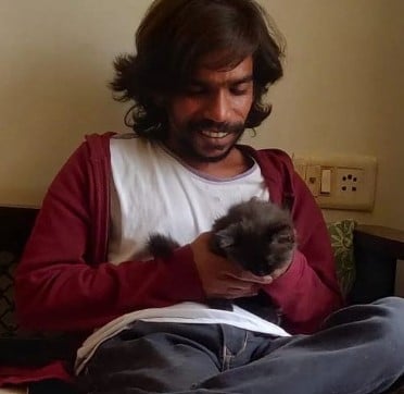 Kumar Saurabh posing with his pet cat