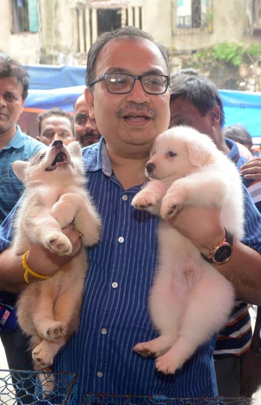 Kunal Ghosh while holding puppies