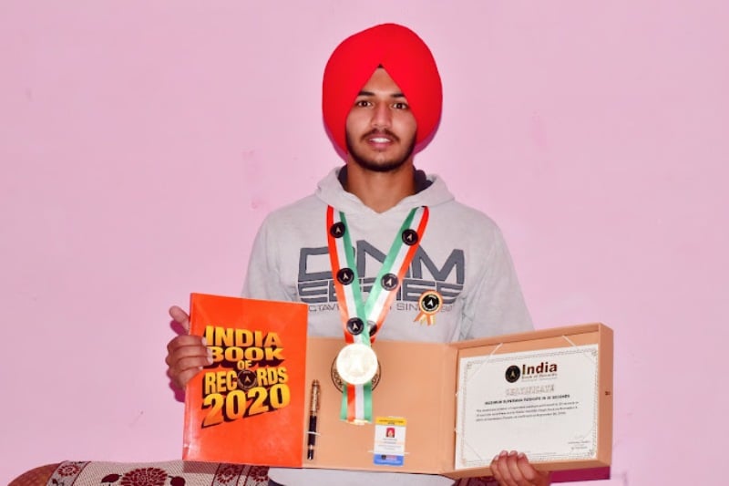 Kuwar Amritbir Singh posing with his record certificate from India Book of Records