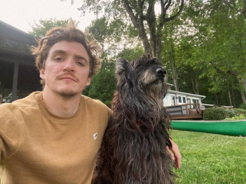 Kyle Gallner posing with his pet dog