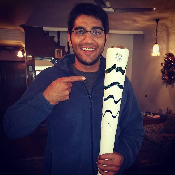 Kynan Chenai holding the Olympic torch at the 2016 Olympics