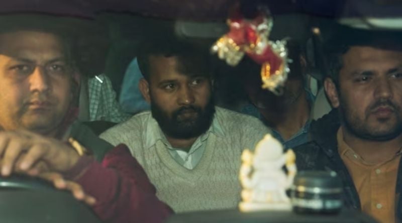 Lalit Mohan Jha (centre) taken into custody