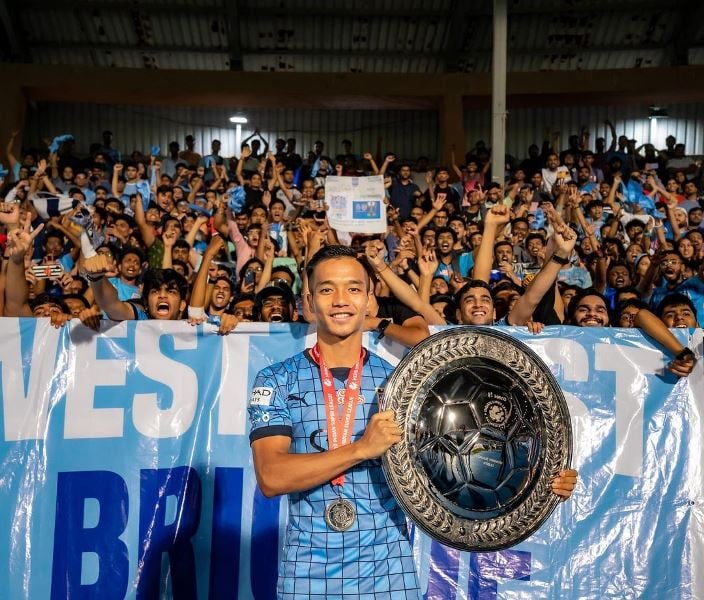 Lallianzuala Chhangte posing with ISL Sheild with Mumbai City FC fans behind