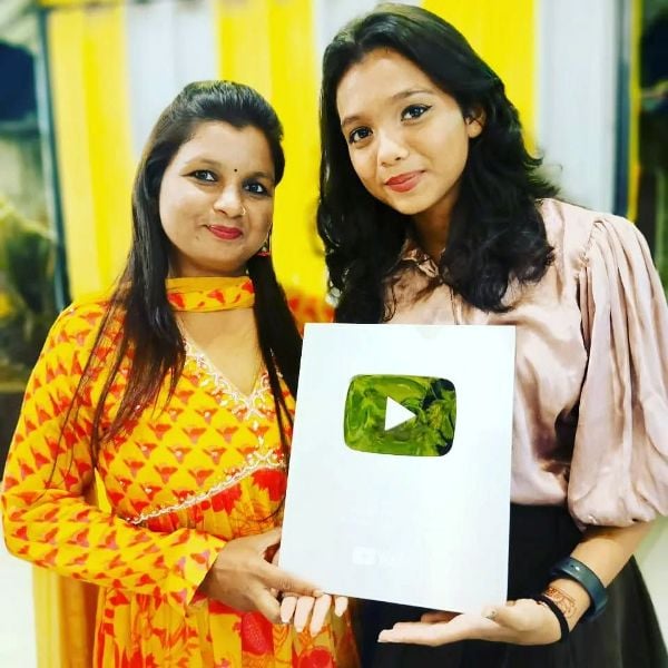 Lavanya Das posing with her mother and the silver YouTube button