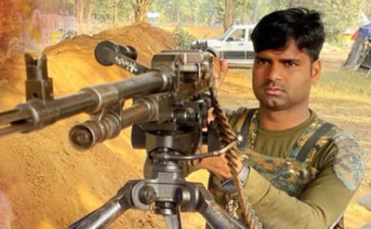 Laxman Kewat posing with his gun