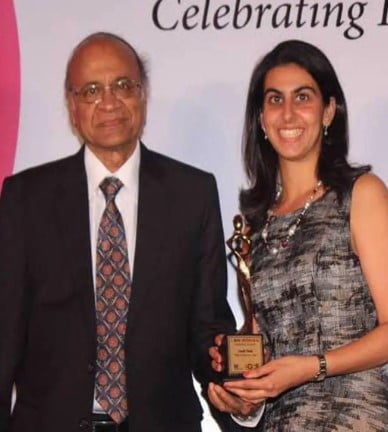 Leah Tata while receiving an award