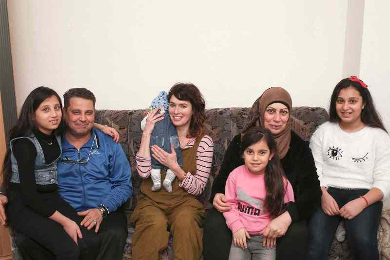 Lena Headey with a Syrian refugee family in Germany