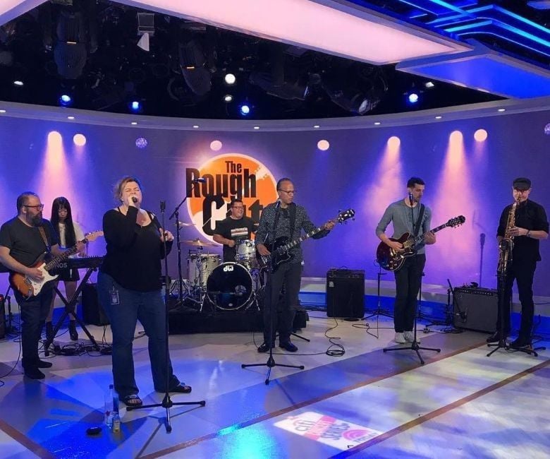 Lester Holt playing bass with his band, The Rough Cuts