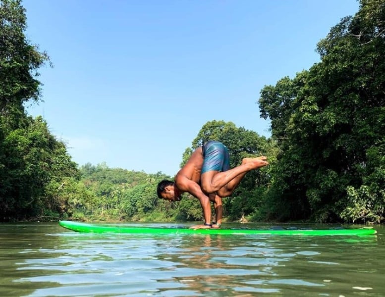 Likith Selvaraj doing handstand on a skateboard