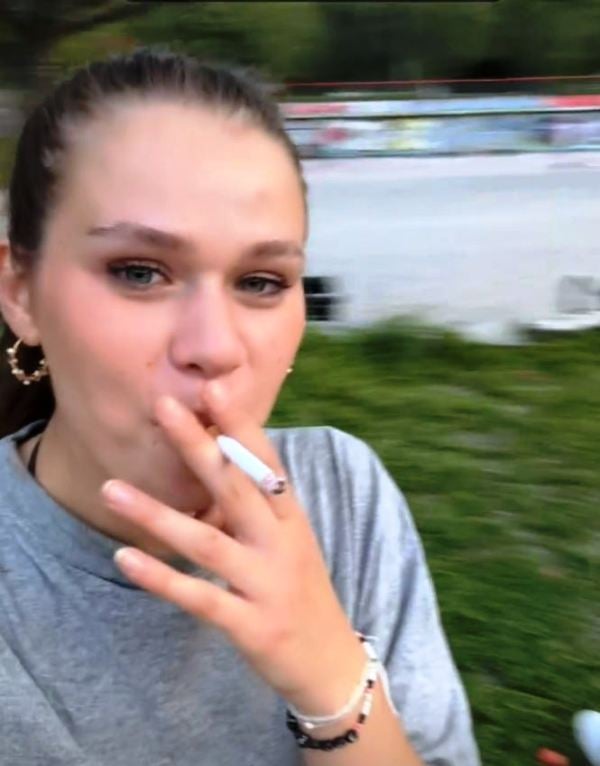Lirie Osmani while smoking a cigarette