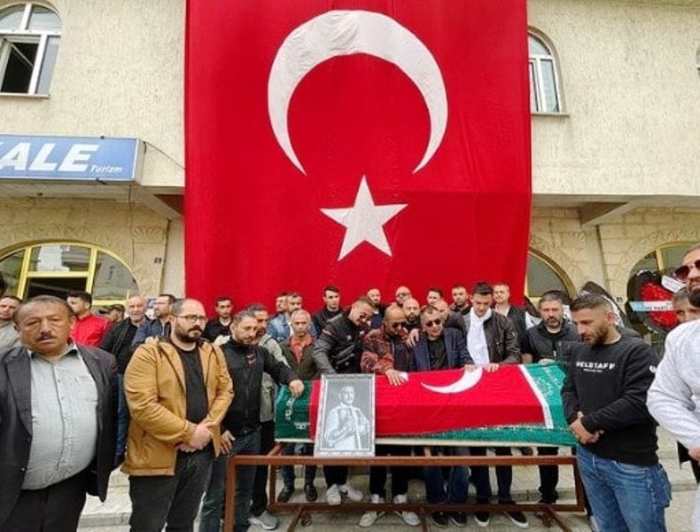 Locals gathered around the coffin of Musa Yamak