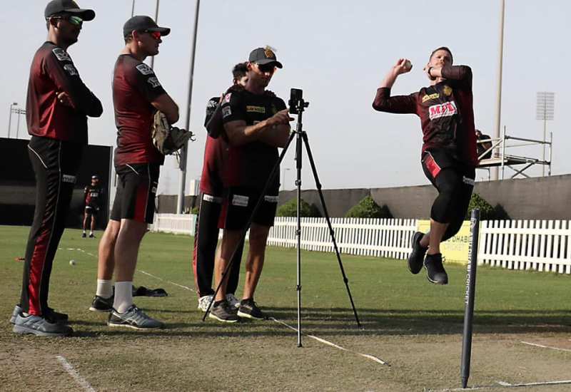 Lockie Ferguson bowling while his brother checking machineroad application