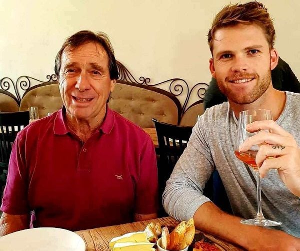 Lockie Ferguson with a glass of wine