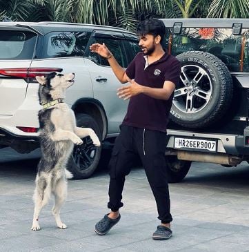 Love Kataria playing with a dog