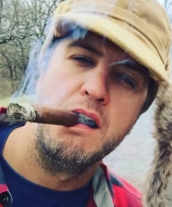 Luke Bryan while smoking a cigar