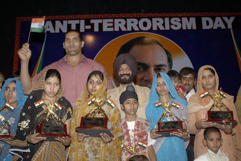 MS Bitta with the WWE wrestler The Great Khali awarded the widows of Indian Army martyrs