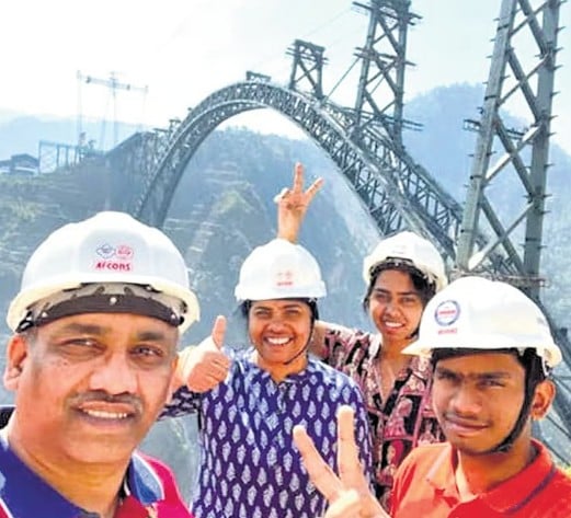 Madhavi Latha posing near the Chenab Bridge with her team members