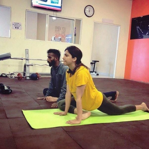 Madonna Sebastian while practicing yoga along with her instructor